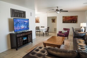 spacious living room with large leather L-shaped sectional sofa