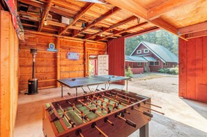 Garage has a ping pong table, and foosball