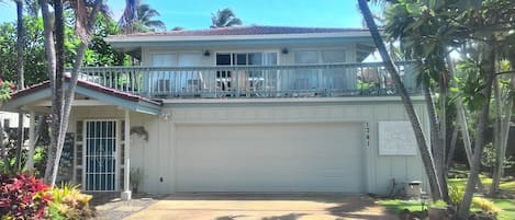 Front of the house with large deck over the garage.
