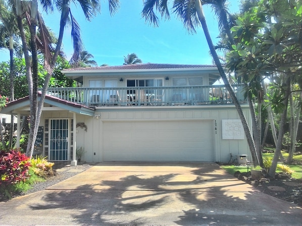 Front of the house with large deck over the garage.
