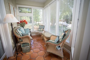 Enter the glass leaded doors into the sun room A great place to read and relax.
