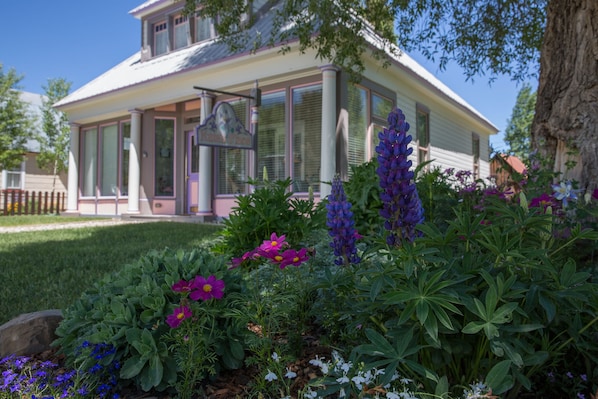 The flower beds in summer are a work of art. Sit on the log bench and enjoy!