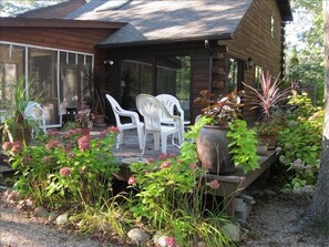 Sunroom accesses deck. Ample seating on outside deck.  gas grill on side deck