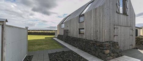 The two floor house is clad with weathered old Siberian larch.