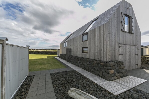 The two floor house is clad with weathered old Siberian larch.