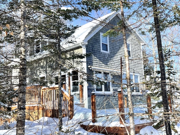 Snowy cottage with wood stove
