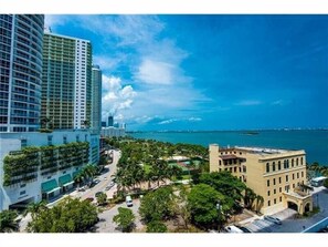 Fully furnished balcony with water views of Biscayne Bay and Margaret Pace Park