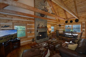 Spacious great room with handcrafted rustic dining table open to kitchen