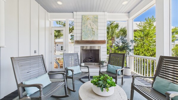Beautiful outdoor gas fireplace- Screened rear porch with seating