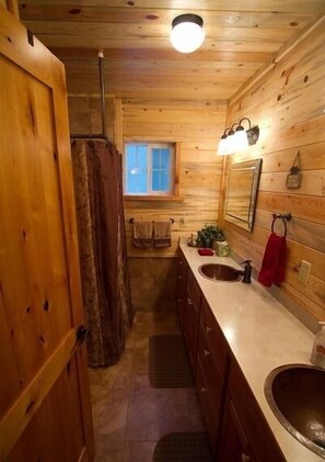 Country classic bathrooms w/ lots of tile and copper