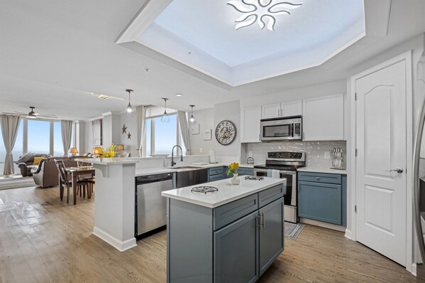 Kitchen open to dining and living and floor to ceiling Gulf views.