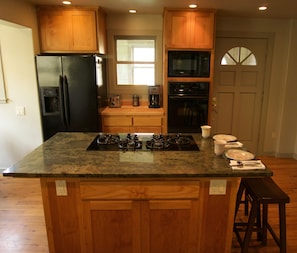 Kitchen w/ Frigidaire appliances, dishwasher, microwave & in-floor radiant heat.