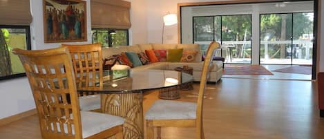 View through diningroom, livingroom, sunroom, & piece of deck, dock, $ water.