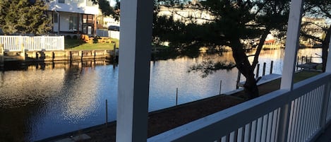 relax on the rear screened in porch overlooking the canal waters