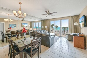 Dining And Family Room With TV. Glass Patio Doors Open to the Balcony