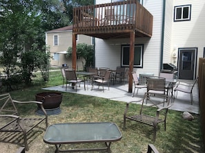 Backyard BBQ area with dining seating for 12 , leisure seating for 4, fire pit