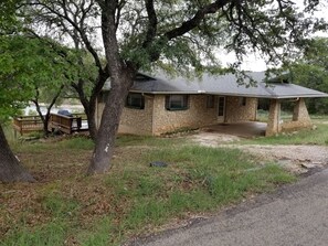 The house and decks behind it, with the lake in the distance