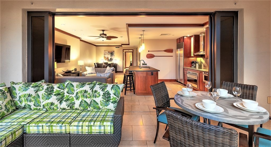 Image of the interior of a Hawaii villa with a dining area and two living areas.