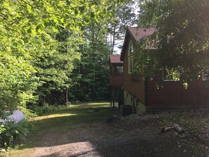 side of the house with screened in house on the deck