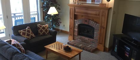 Living area with plenty of light, gas fireplace and new 49" flat screen TV.