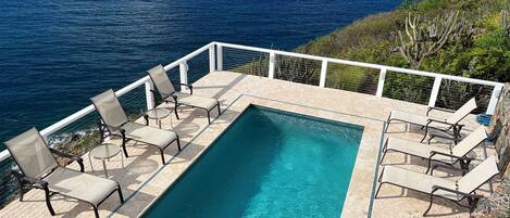 large pool and deck area with constant ocean breezes and lots of seating 