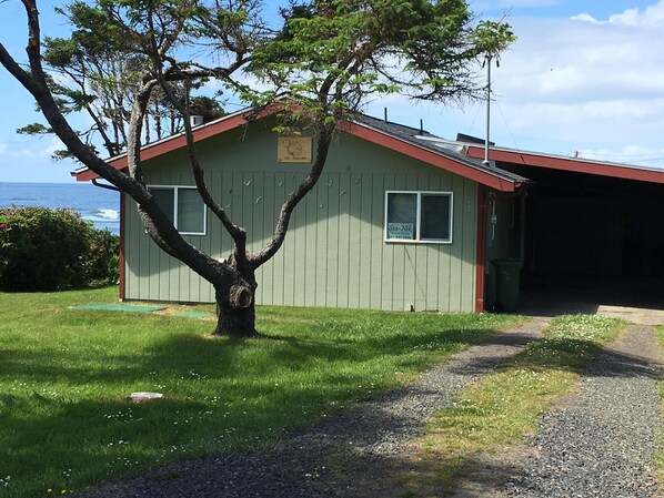 Front exterior with carport on east side of the house.