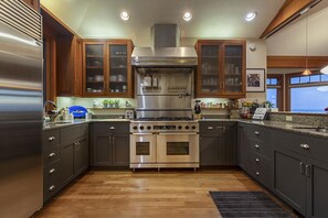 Chef's kitchen with professional grade appliances and granite countertops