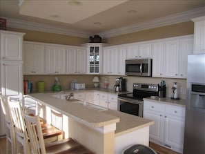 Fully equipped kitchen provides a wonderful gathering area.