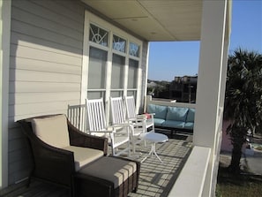 The front porch offers pure relaxation. Enjoy the sights and sounds of the ocean