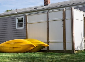Outdoor shower with hot water and kayaks