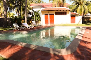 Pool with pool house, which includes one full bathroom