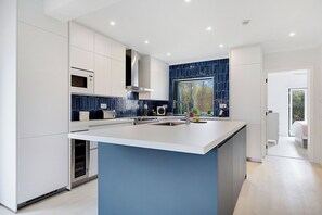 Large island with sink and plenty of prep space.