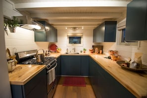 Full size kitchen with custom maple counter tops.