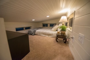 Cozy upstairs bedroom with queen-size bed.