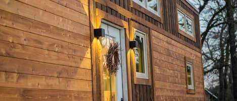 This elegant tiny house is clad in hand-made Shou Sugi Ban cedar siding.