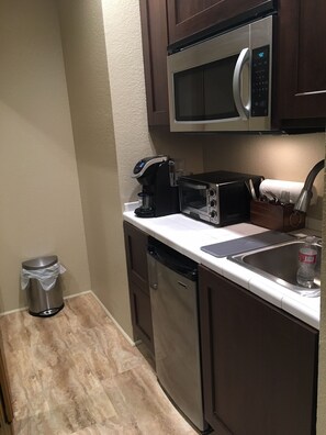 Kitchenette includes portable burners, convection broiler, microwave, coffee 