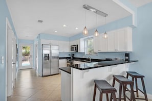 Open kitchen with door to the pool!