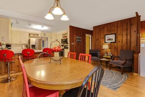 Two upholstered chairs are located opposite the kitchen table.