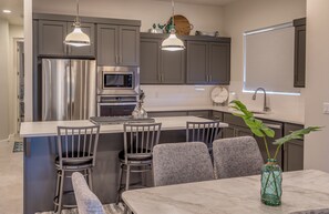 Kitchen - The kitchen is fully stocked with all the dishes, cookware, baking pans, and cutlery you will need for meal preparations and includes stainless steel appliances and granite counter tops.