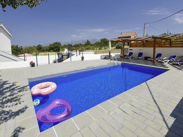 Water, Sky, Cloud, Building, Swimming Pool, Azure, House, Shade, Outdoor Furniture, Flooring
