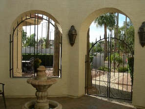 The courtyard is gated with a serene fountain