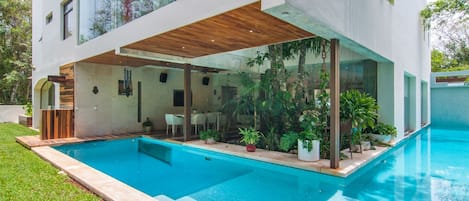 The backyard pool, with natural salt water wraps around the house