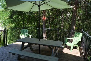 Back Deck with Weber Grill and outdoor dining furniture/umbrella/string lighting