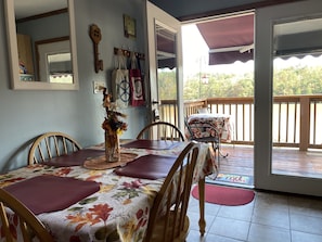Double French doors leading onto deck. View of lake from dining room table