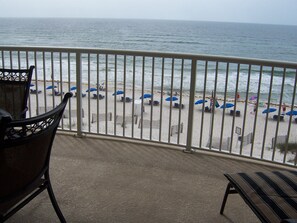 Balcony View Looking Down At Beach 
Ike's Beach Service Provides Rental Chairs