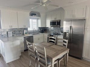 Kitchen / Dining area with expandable table to accommodate six people.
