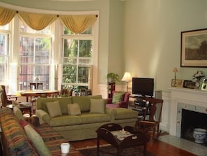 large fireplaced living room with high ceilings