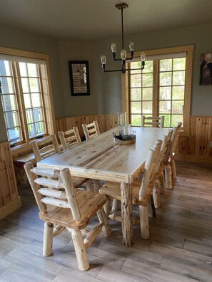 Dining table seats 10 with additional log bench.