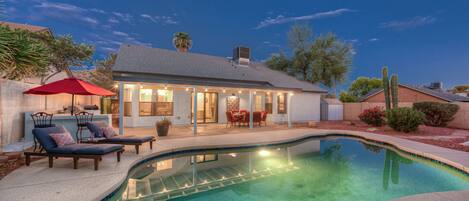 private heated pool with outdoor lighting