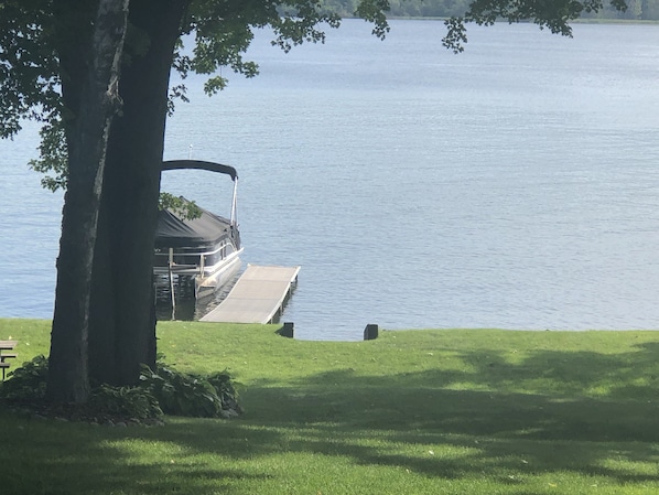 125’ of shared lakefront on Lake Charlevoix with private dock & pontoon hoist. 